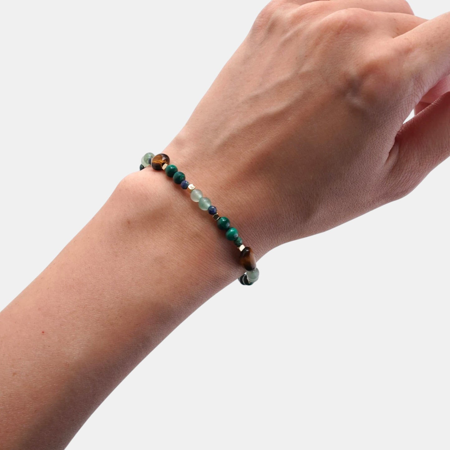 Hollywood Road Stories multi-stone beaded stretch bracelet featuring tiger's eye, malachite, and fluorite on a wrist.