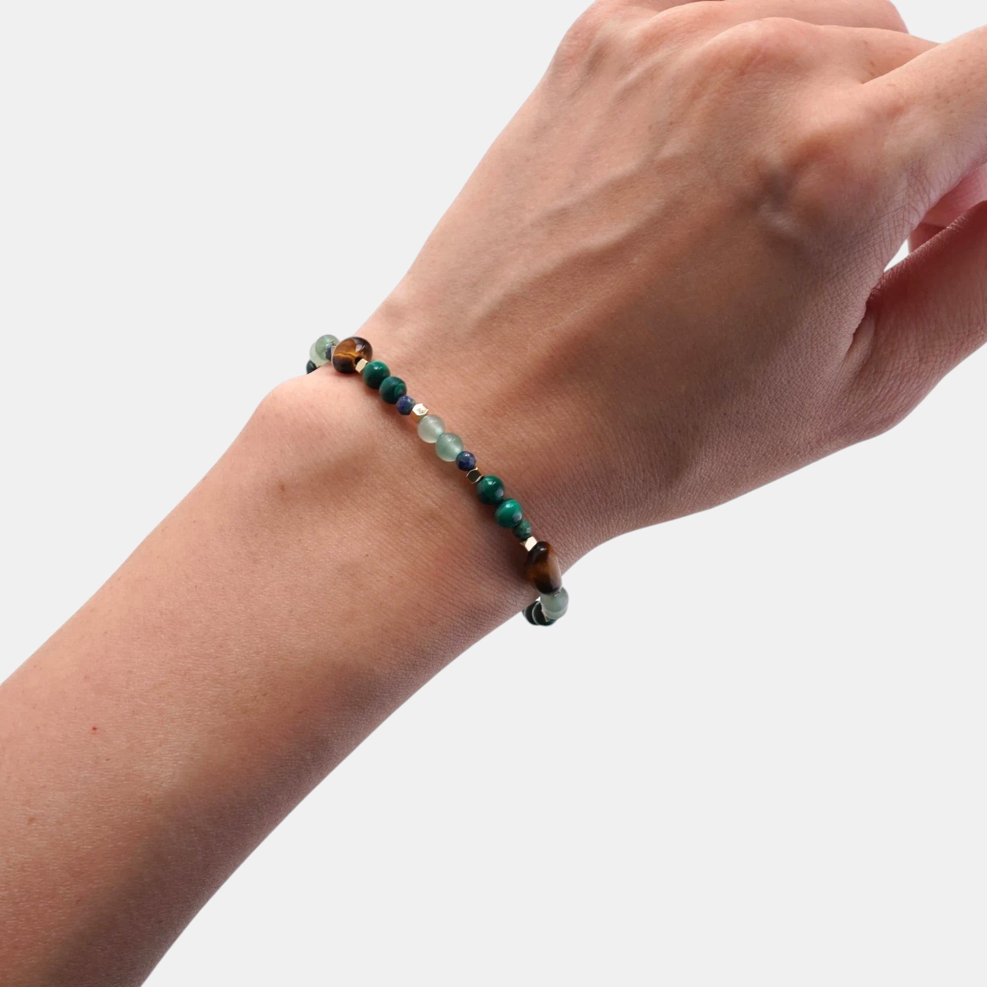 Hollywood Road Stories multi-stone beaded stretch bracelet featuring tiger's eye, malachite, and fluorite on a wrist.