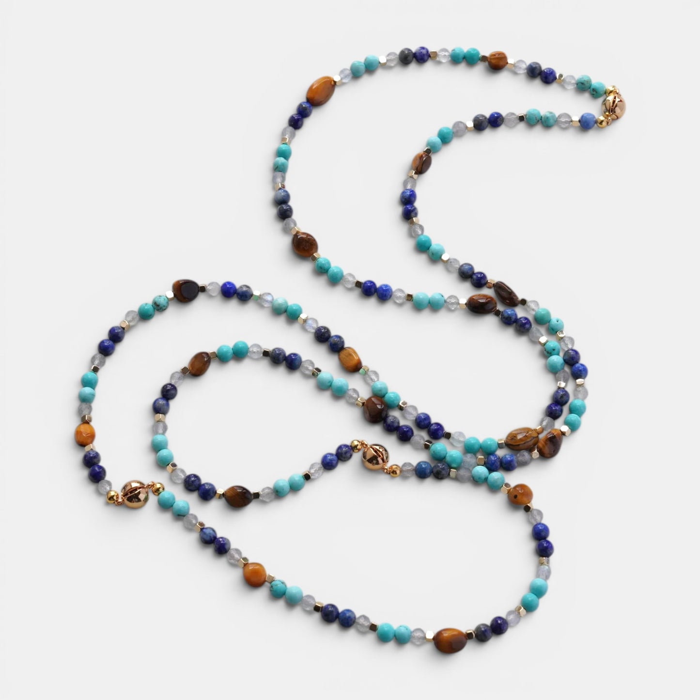 Hollywood Road Stories long necklace with turquoise, lapis lazuli, tiger's eye, and quartz beads with gold accents.