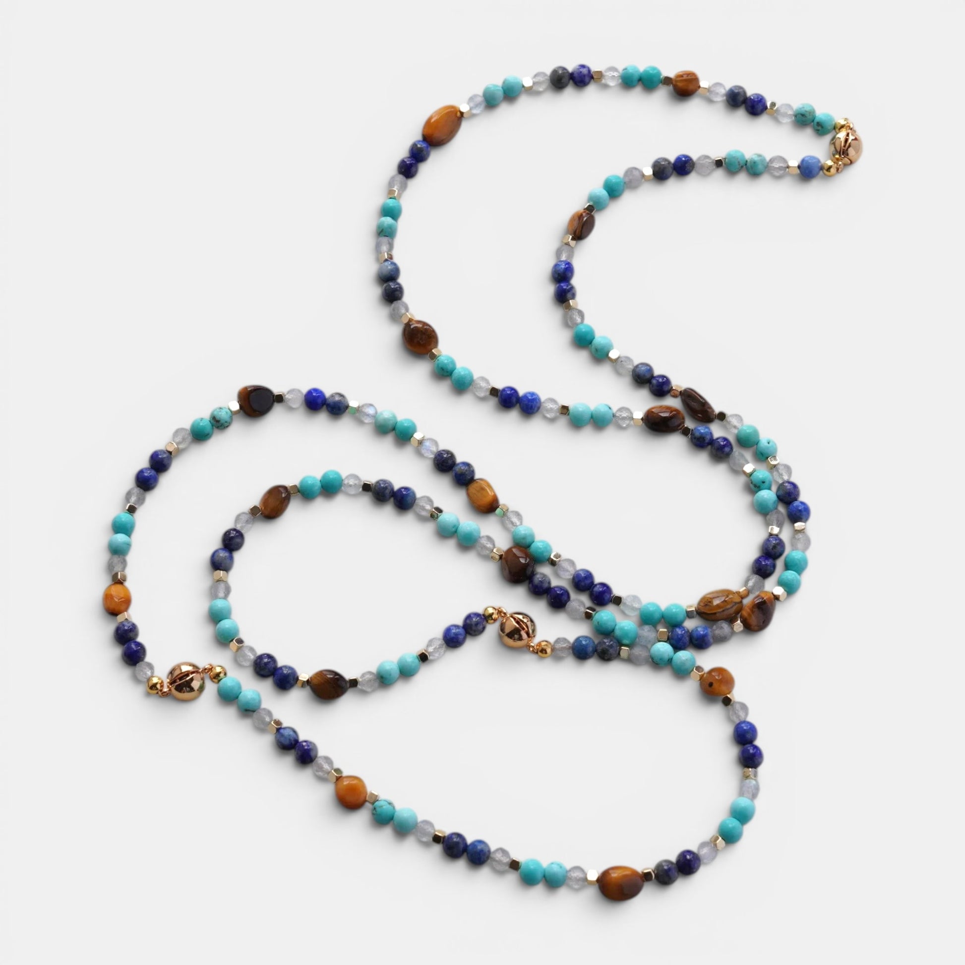 Hollywood Road Stories long necklace with turquoise, lapis lazuli, tiger's eye, and quartz beads with gold accents.