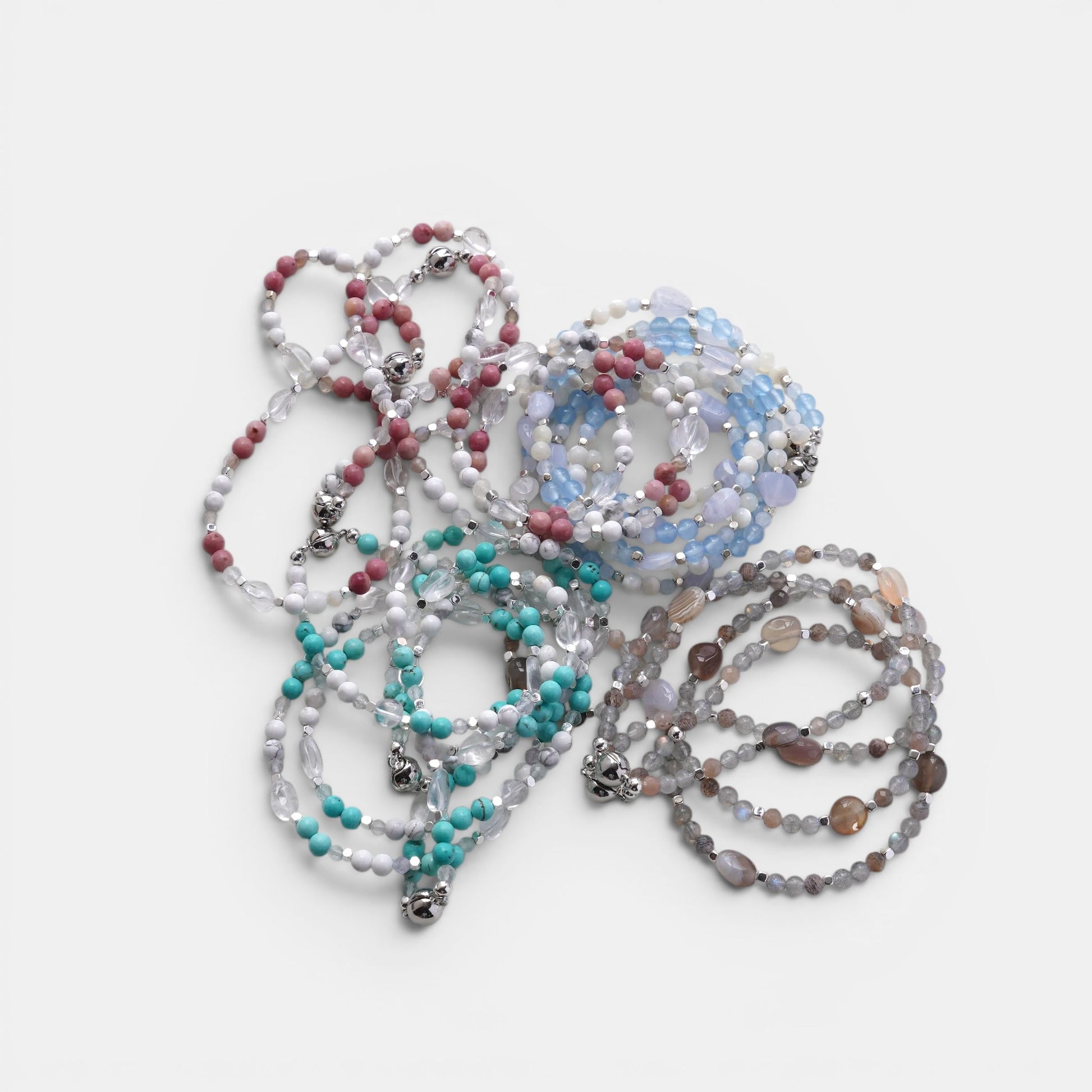 Hollywood Road Stories multi-strand gemstone bracelets featuring faceted beads in blue, pink, turquoise, and grey.