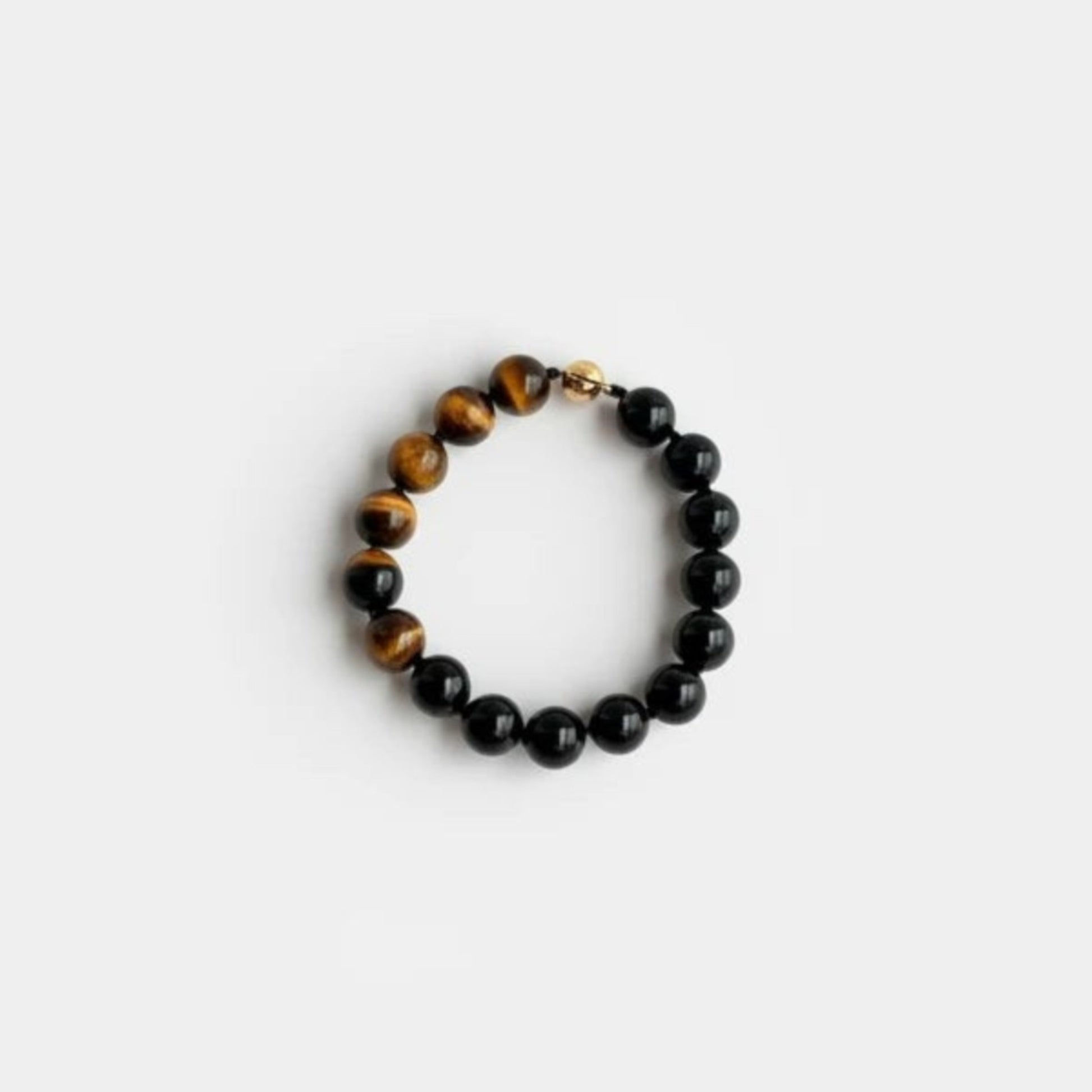 Hollywood Road Stories beaded bracelet featuring polished black onyx and golden-brown tiger's eye stones on elastic.