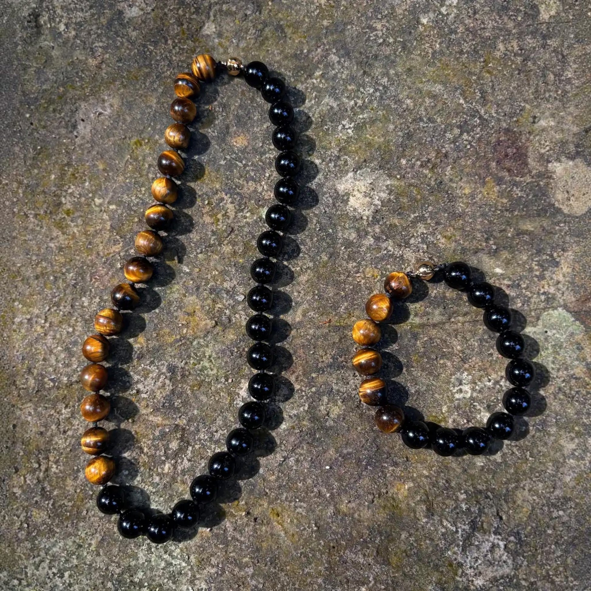 Hollywood Road Stories beaded necklace and bracelet set featuring polished black onyx and tiger's eye stones on stone.