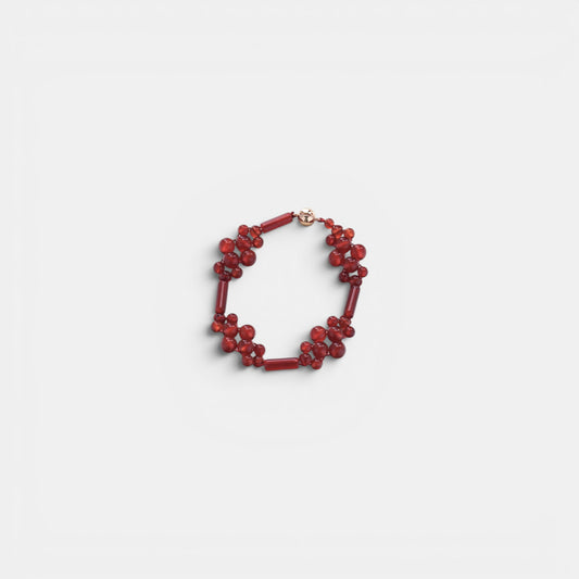 Hollywood Road Stories red beaded cluster bracelet with polished round and cylindrical beads on a white background.