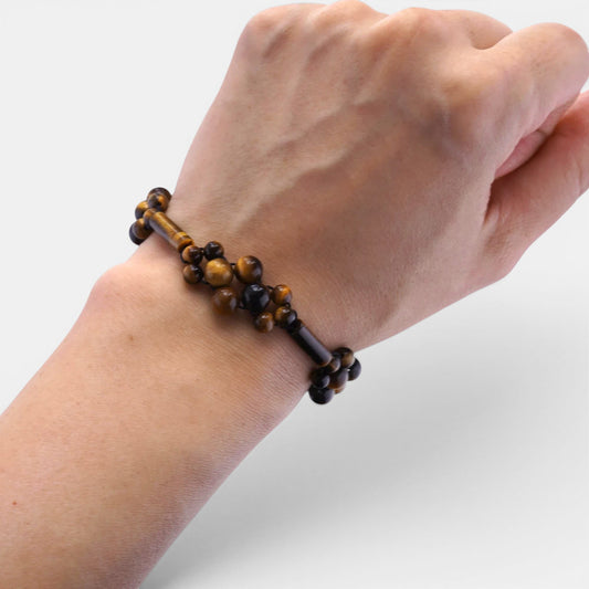 Hollywood Road Stories Tiger Eye beaded bracelet with cylindrical spacers worn on a wrist against a white background.